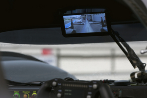 The screen is mounted in the same location as a normal rear-view mirror